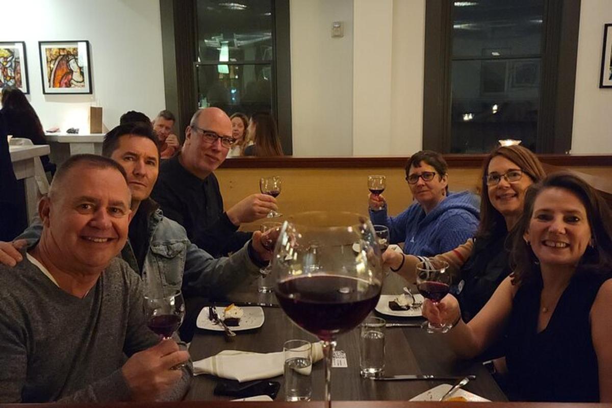 a group of people sitting at a table with wine glasses