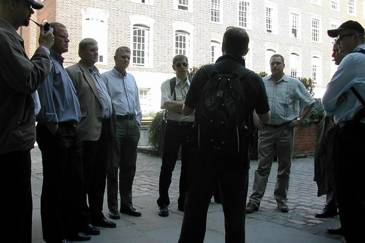 a group of men standing in front of a building