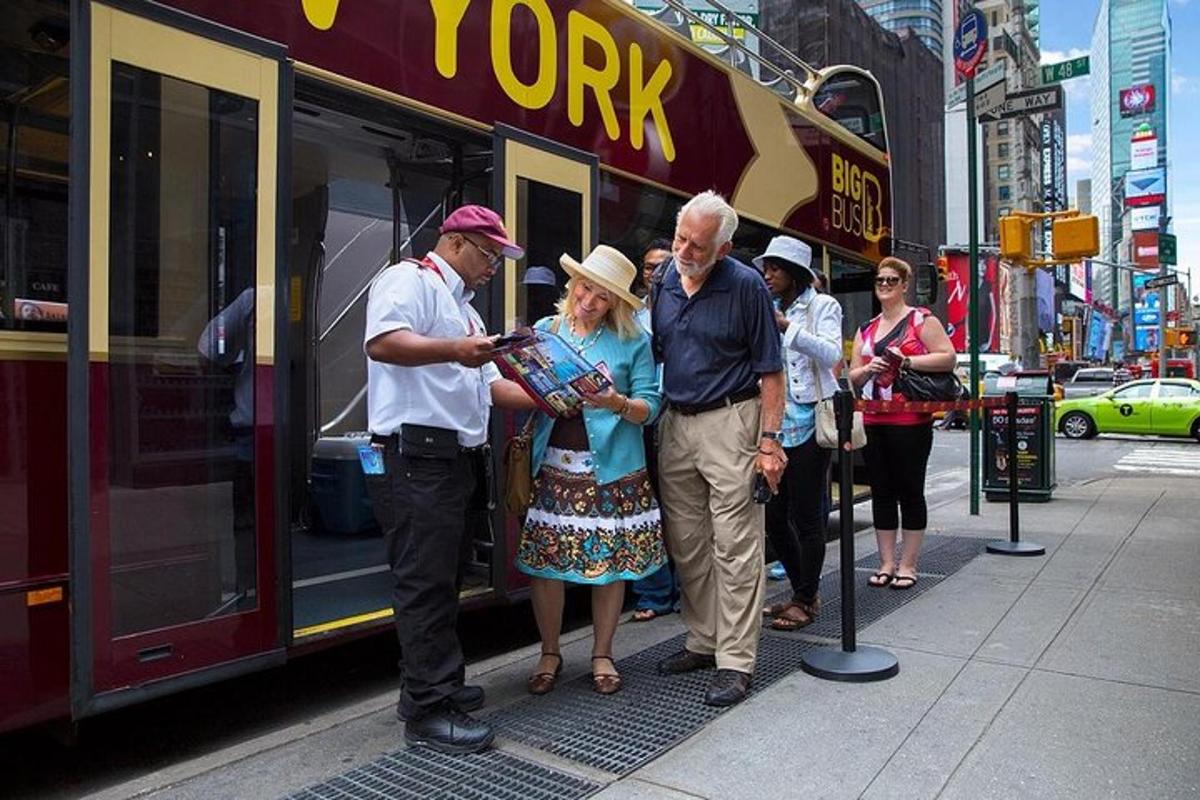 a group of people standing next to a bus