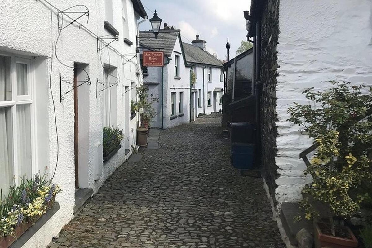 an alley with white houses and a cobblestone street