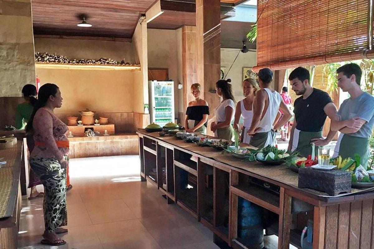 a group of people standing in a kitchen preparing food