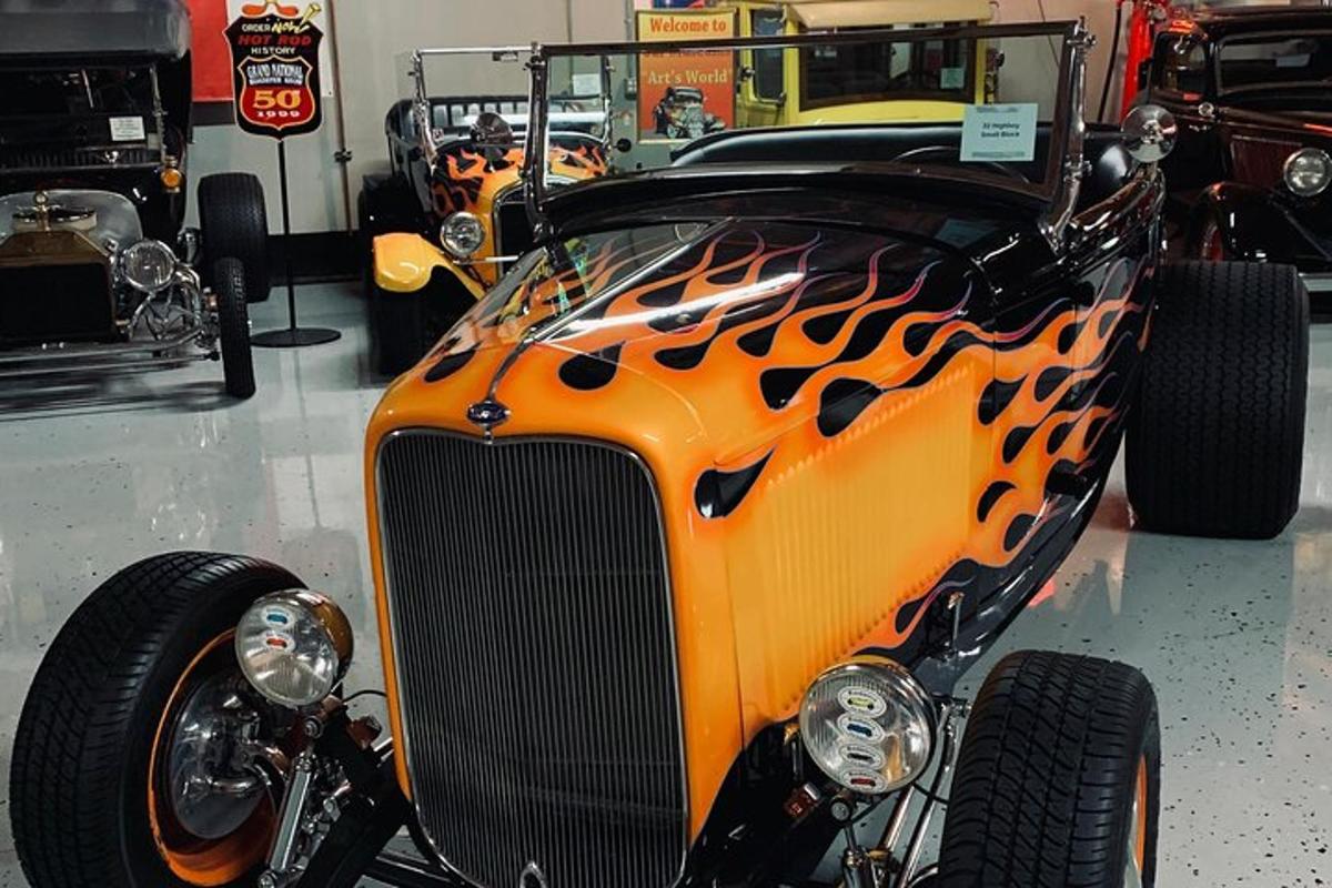 an orange and black car parked in a garage