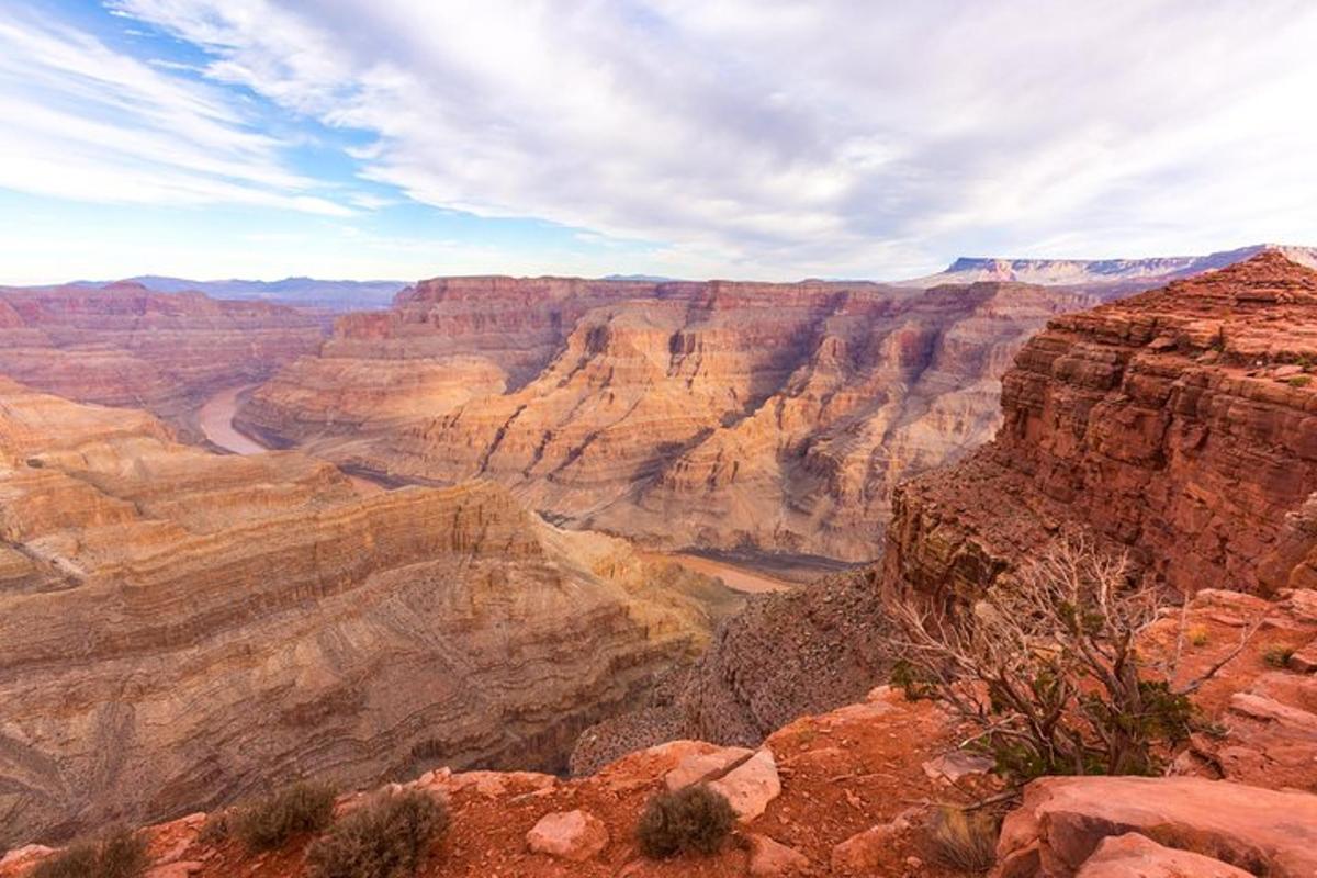 a view of the grand canyon under a cloudy sky