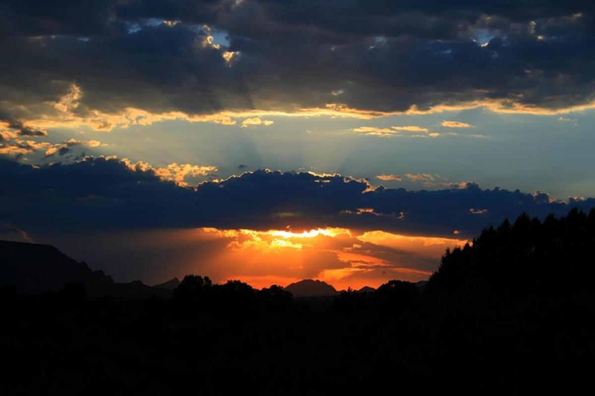 a sunset with the sun shining through the clouds