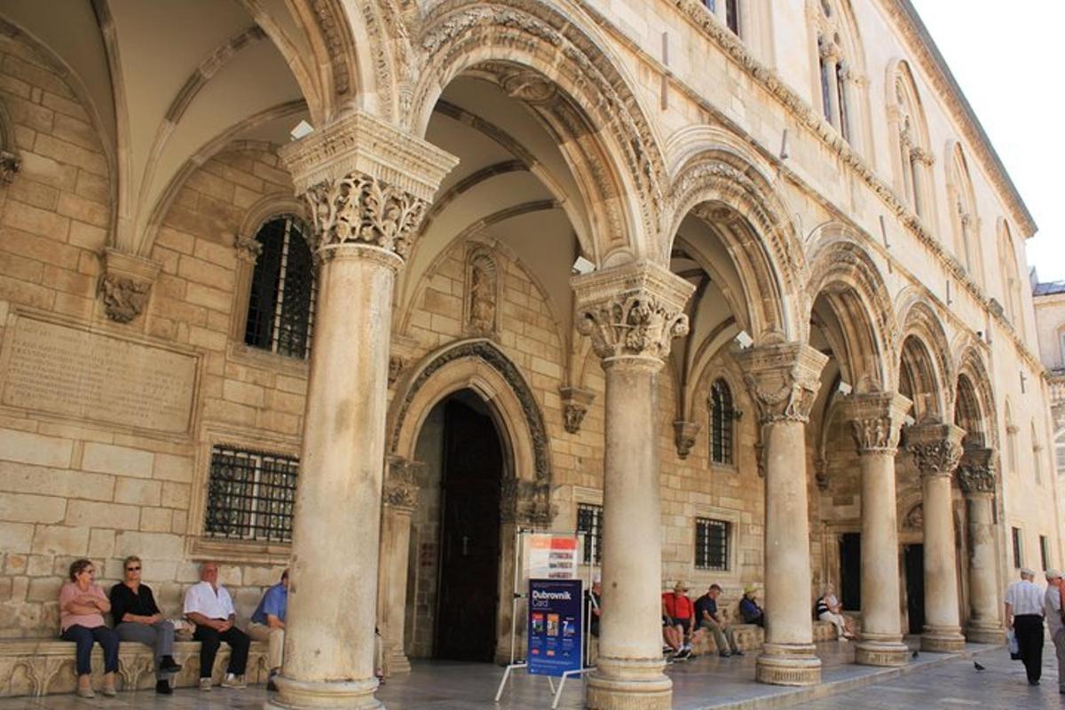 a group of people sitting in front of a building