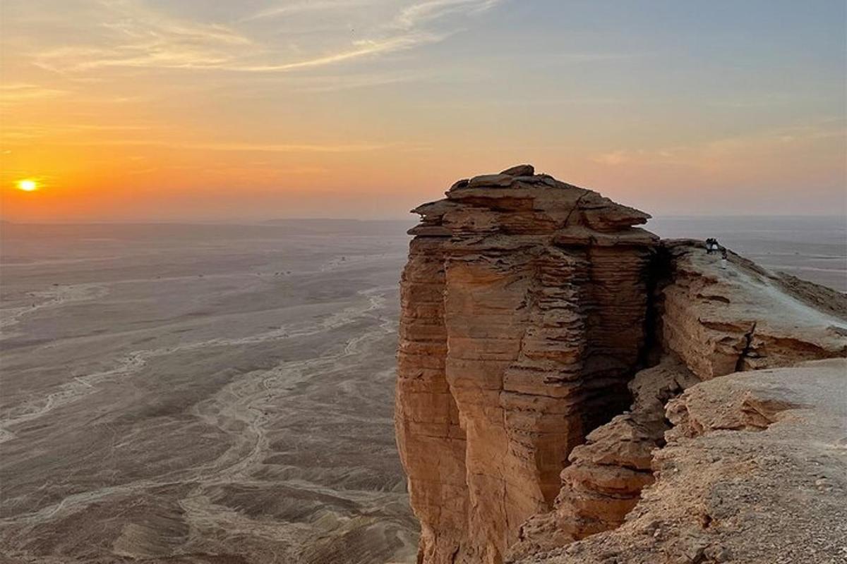 a view of a mountain in the desert at sunset