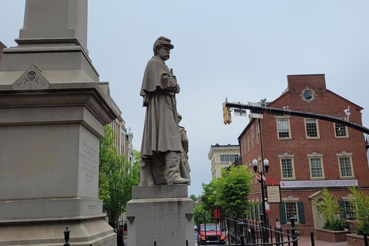 a statue of a man standing on a street