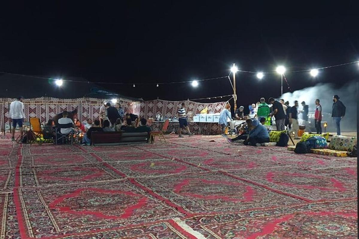 a group of people sitting on the floor of a market