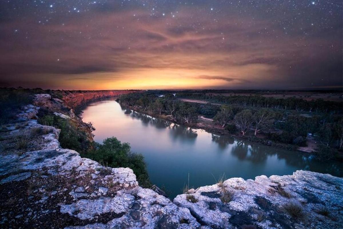 a view of a river at night with the stars