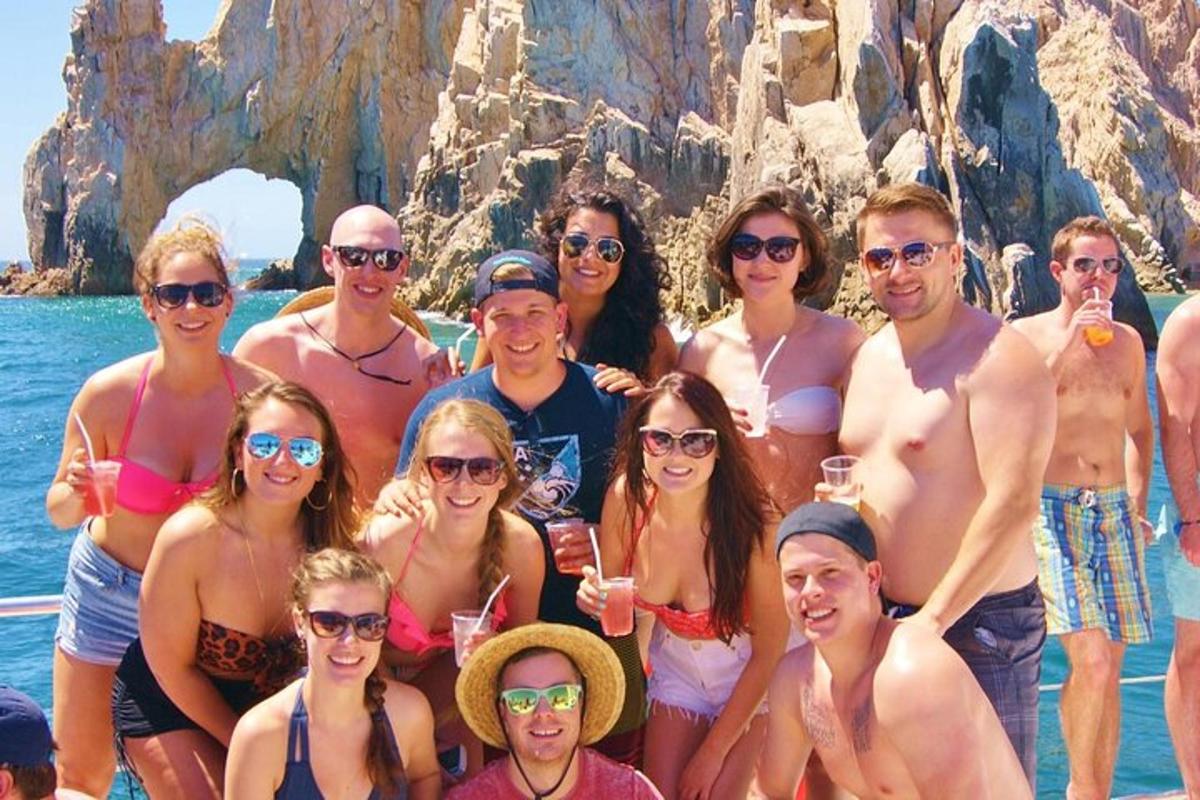 a group of people posing for a picture on the beach