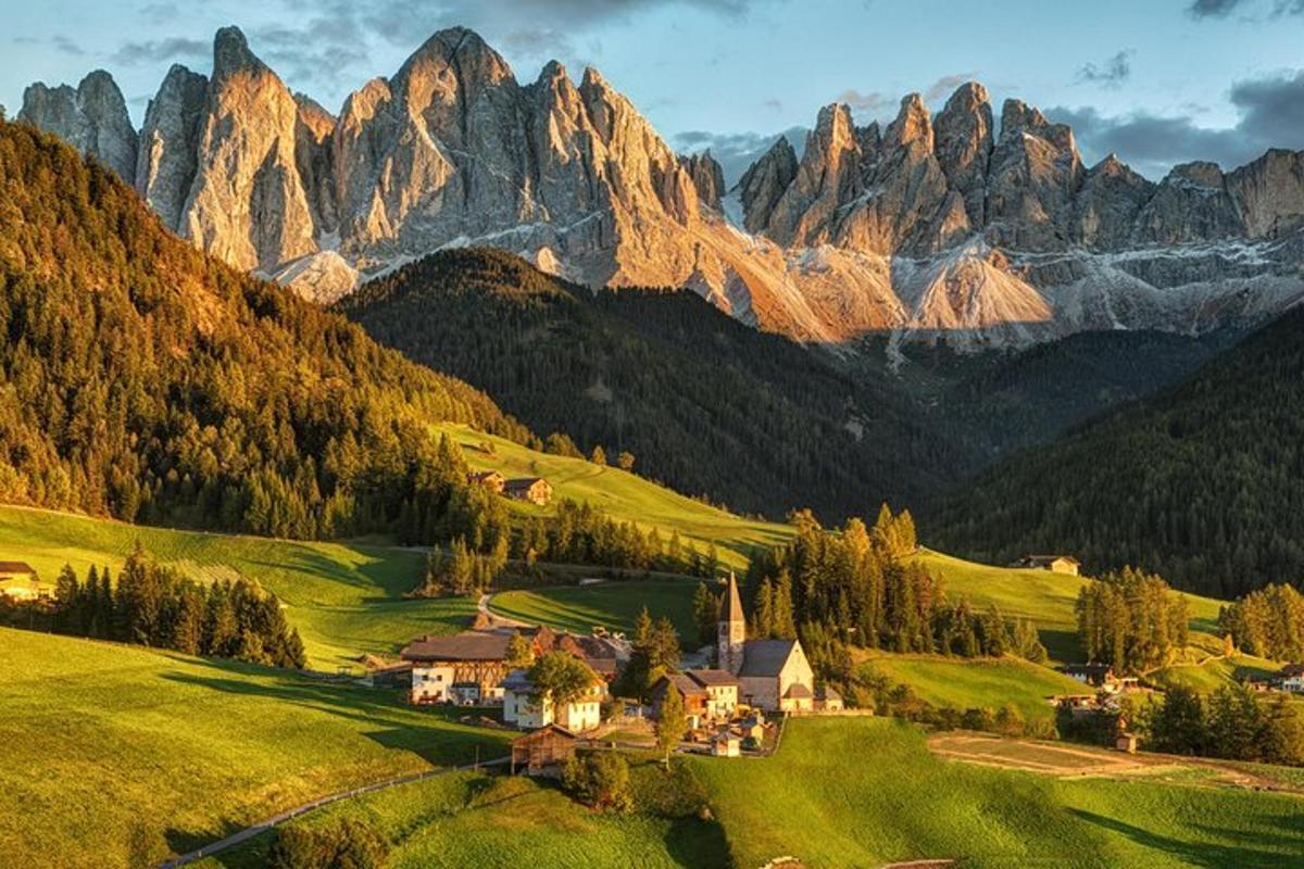a village in a valley with mountains in the background