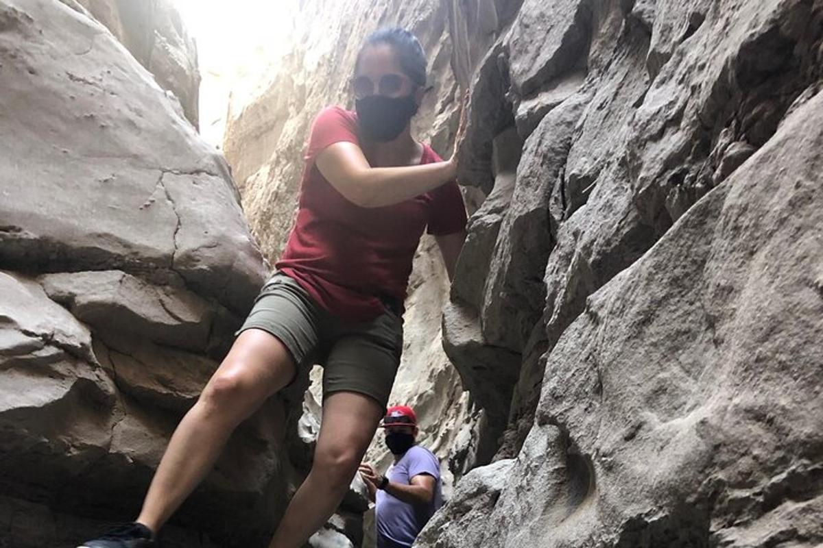 a woman is climbing on a rocky mountain