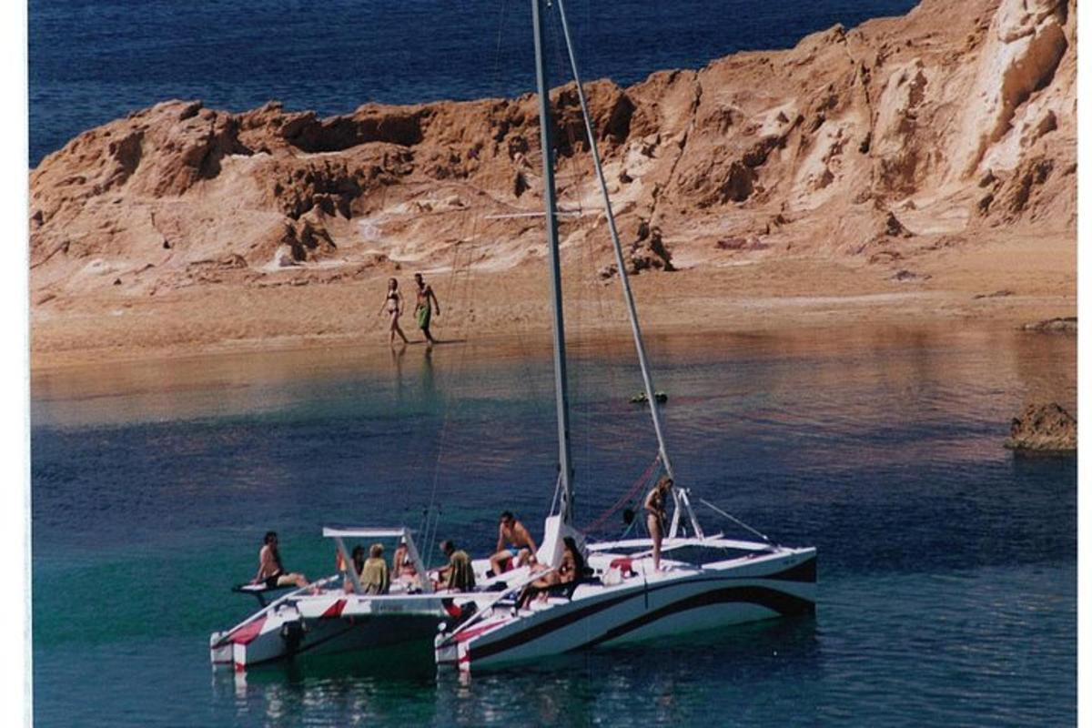 a group of people on a sail boat in the water