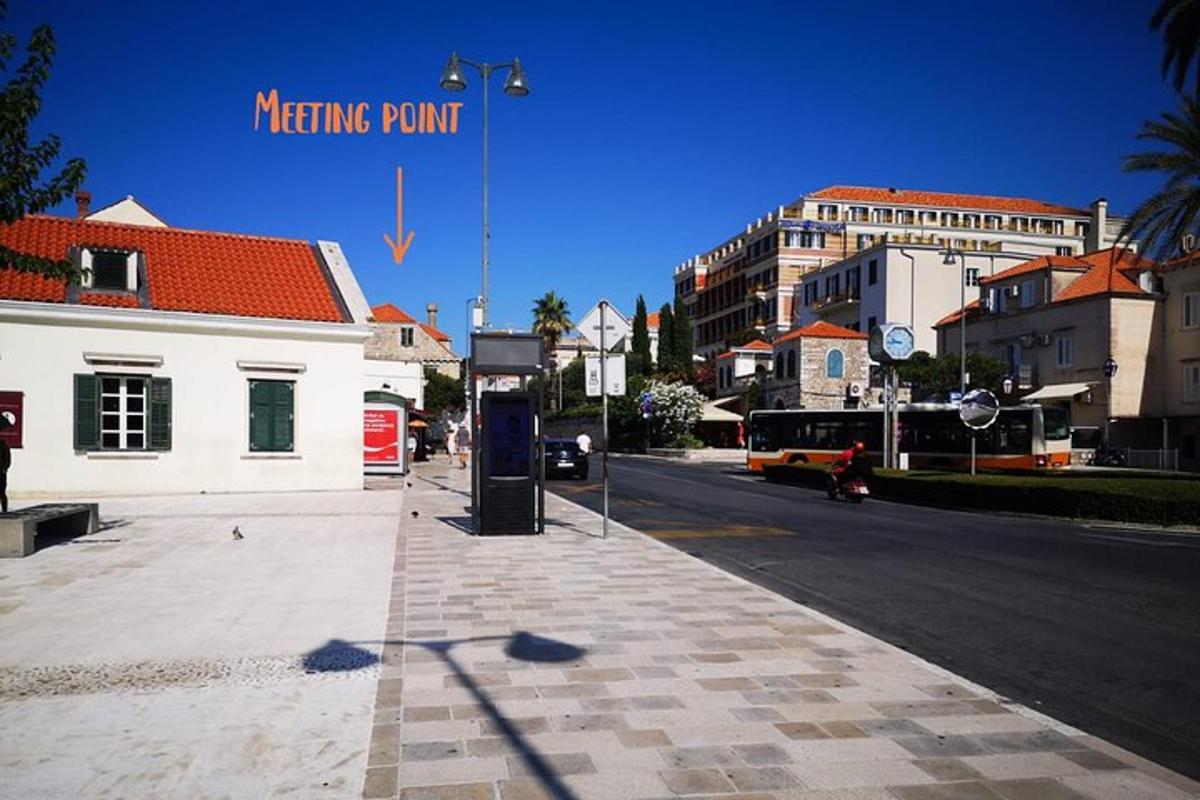 a city street with a sign for a meeting point