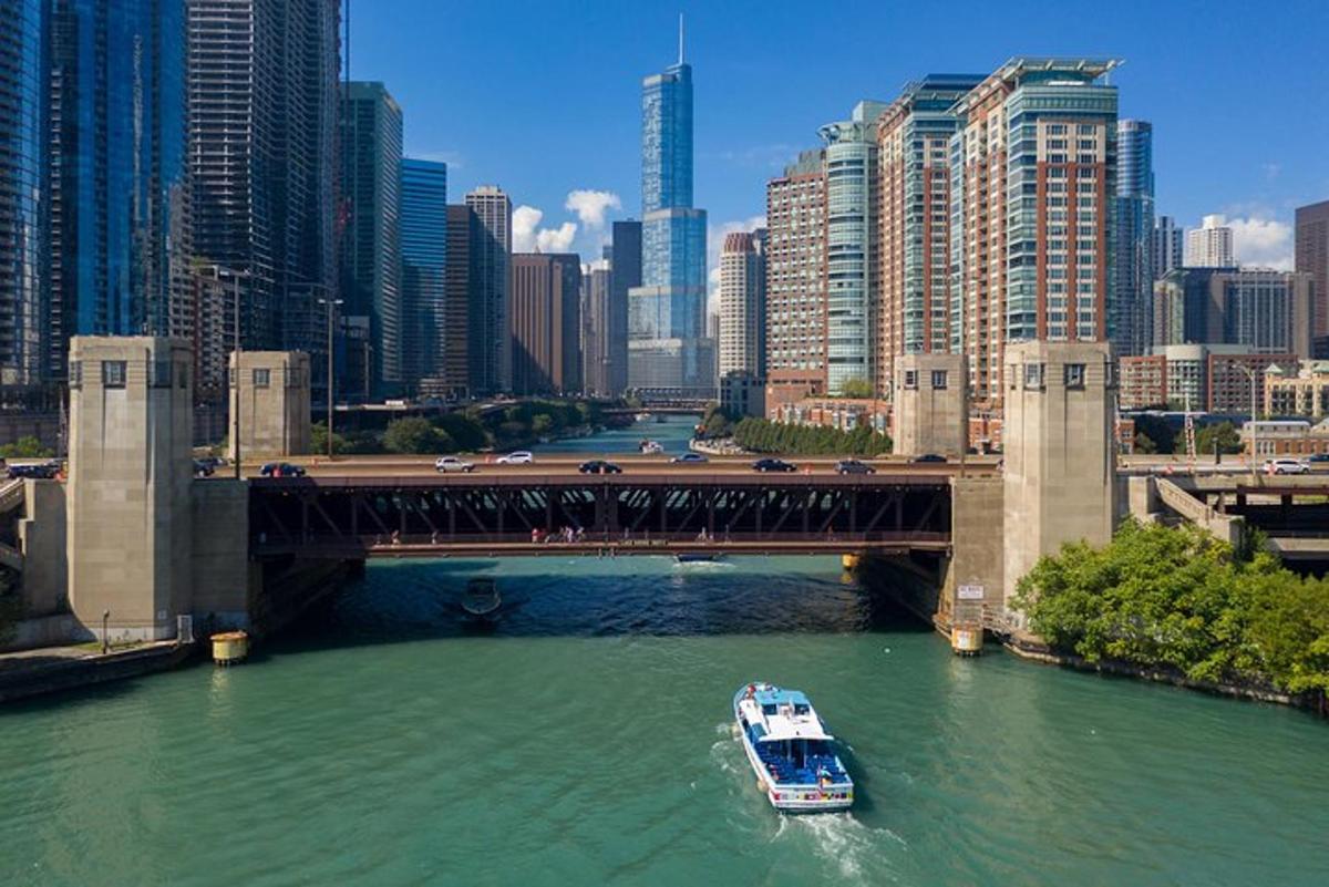 a boat in the water under a bridge in a city