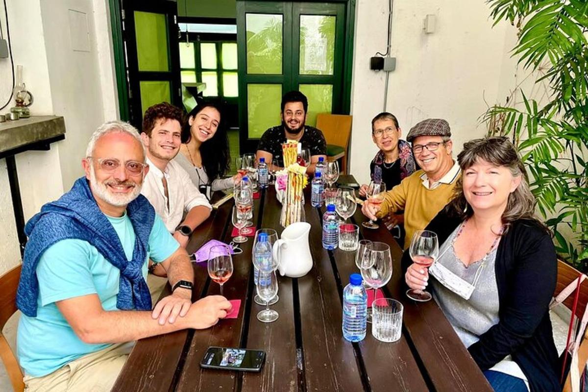 a group of people sitting around a wooden table