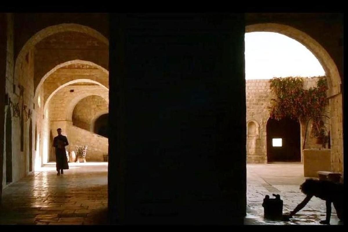 a man walking through an alley in a building