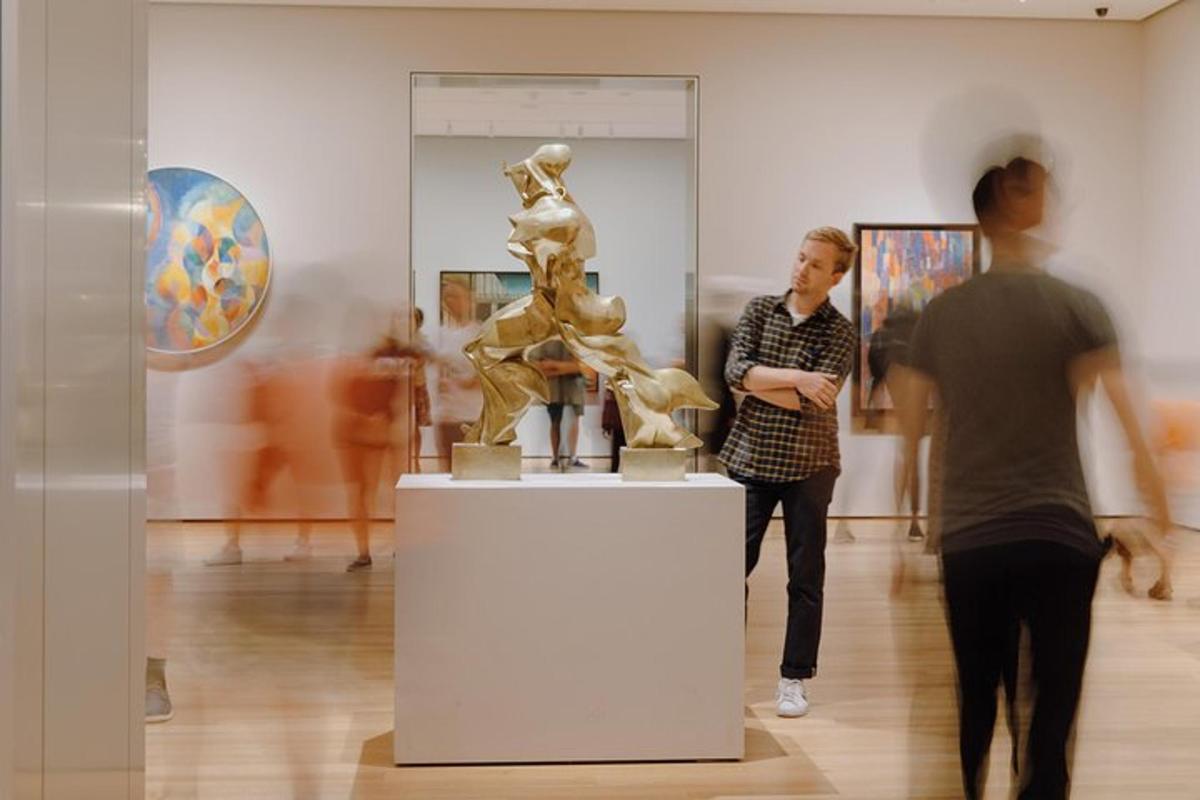 two people looking at a sculpture in a museum