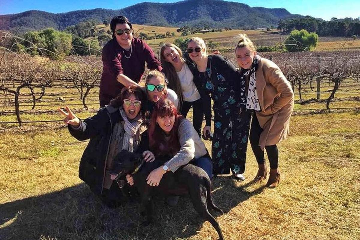 a group of women posing for a picture in a field