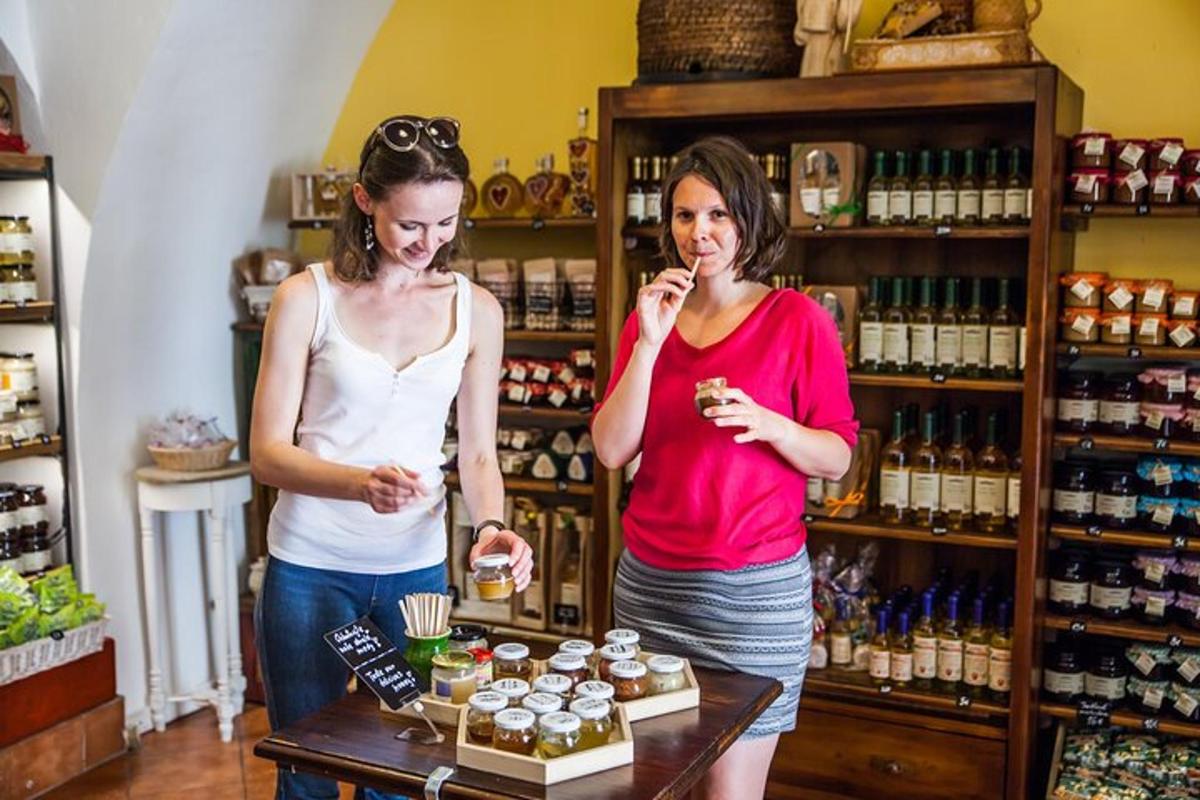 two women standing in a store eating food