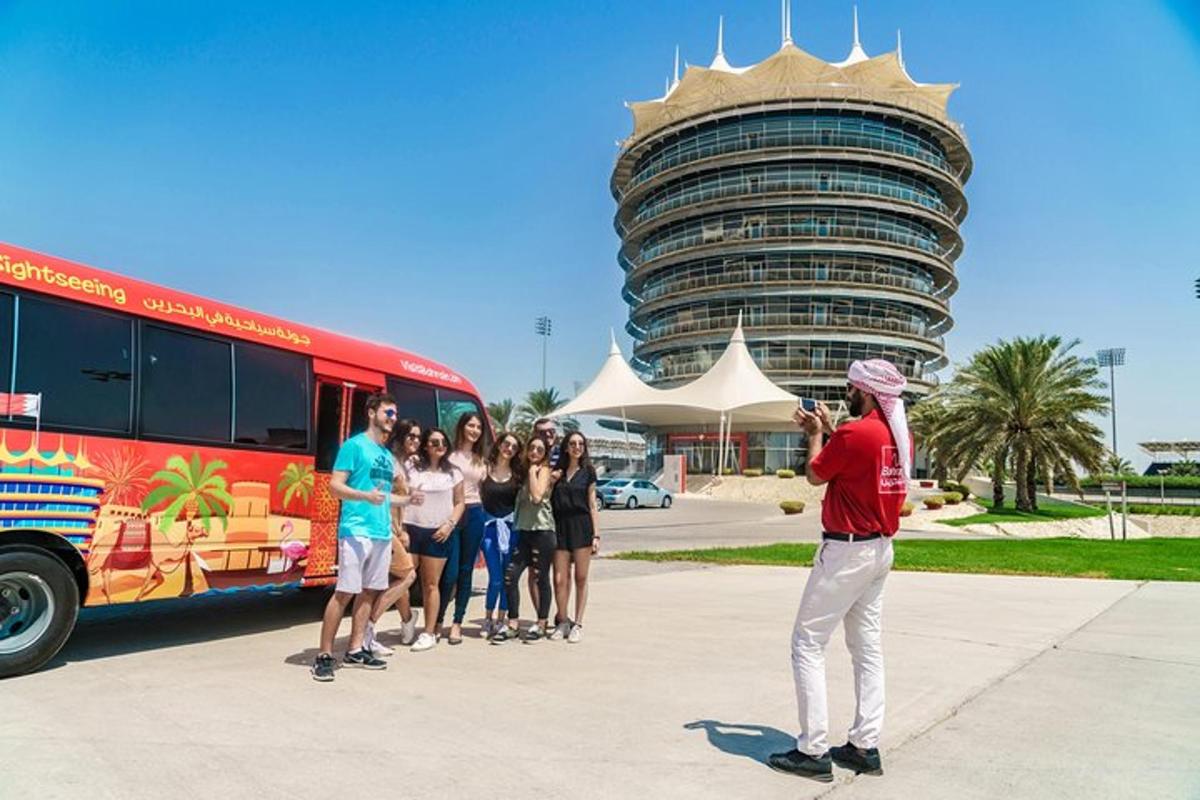 a group of people standing next to a bus