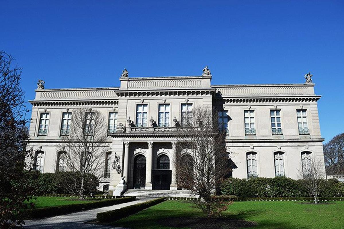 a large white building with a yard in front of it