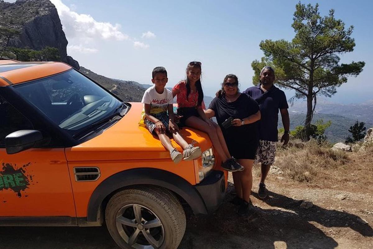 a group of people sitting on the back of an orange truck