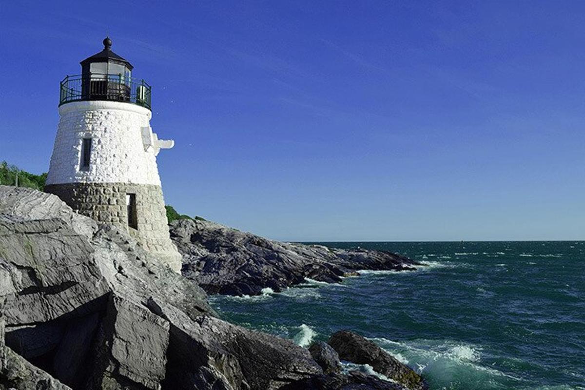 a lighthouse on the rocks near the ocean