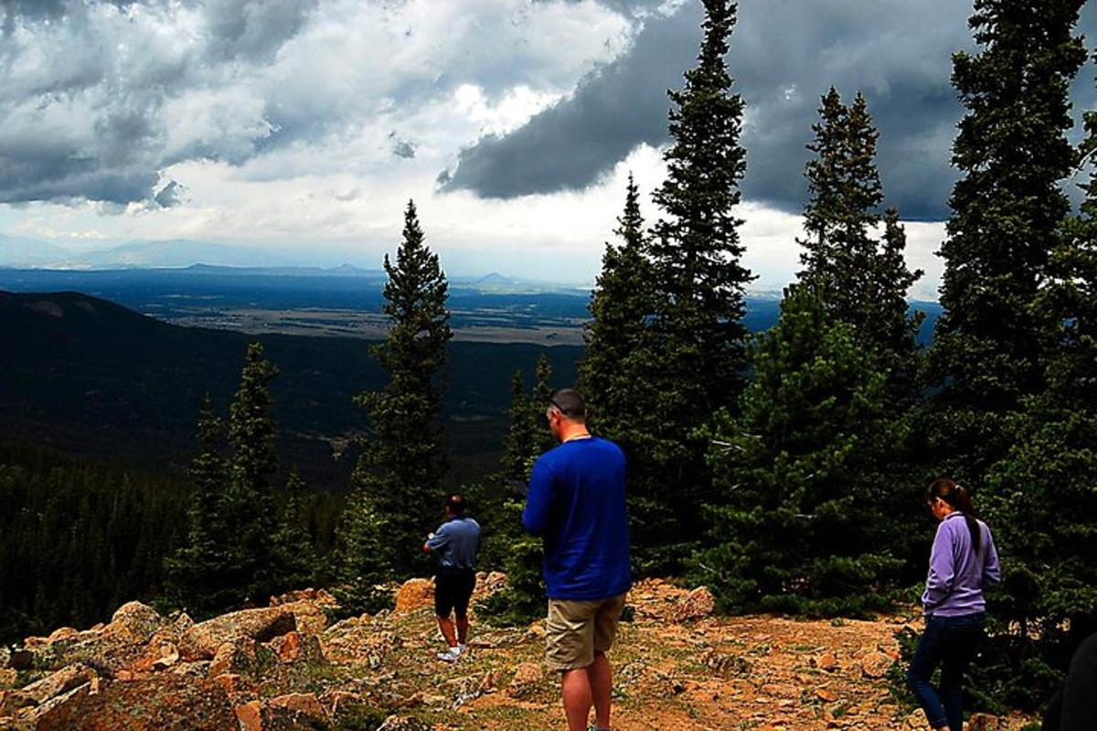 a group of people standing on top of a mountain