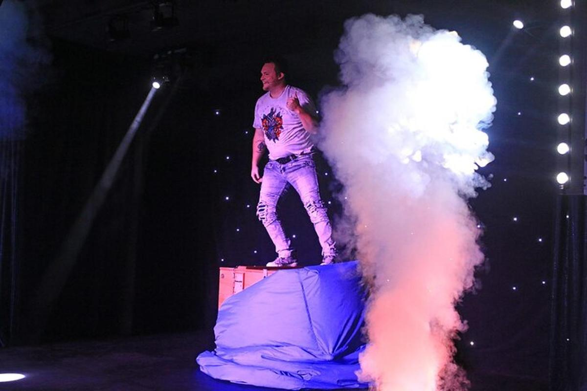 a man standing on a stage with a cloud of smoke