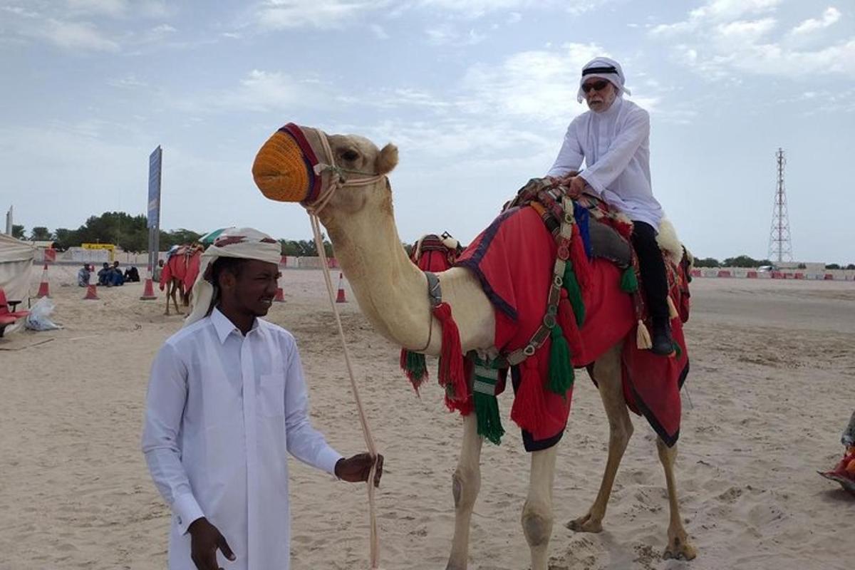 a man standing next to a person riding a camel