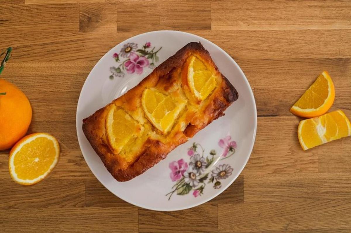 a plate with a piece of bread with orange slices