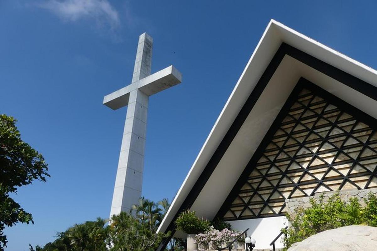 a cross in front of a building with a church