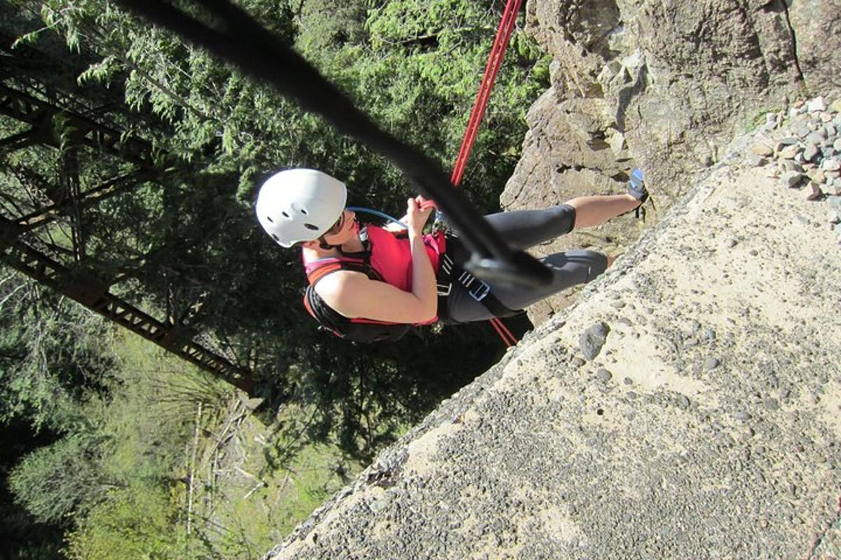 a man is rappelling down a rock wall