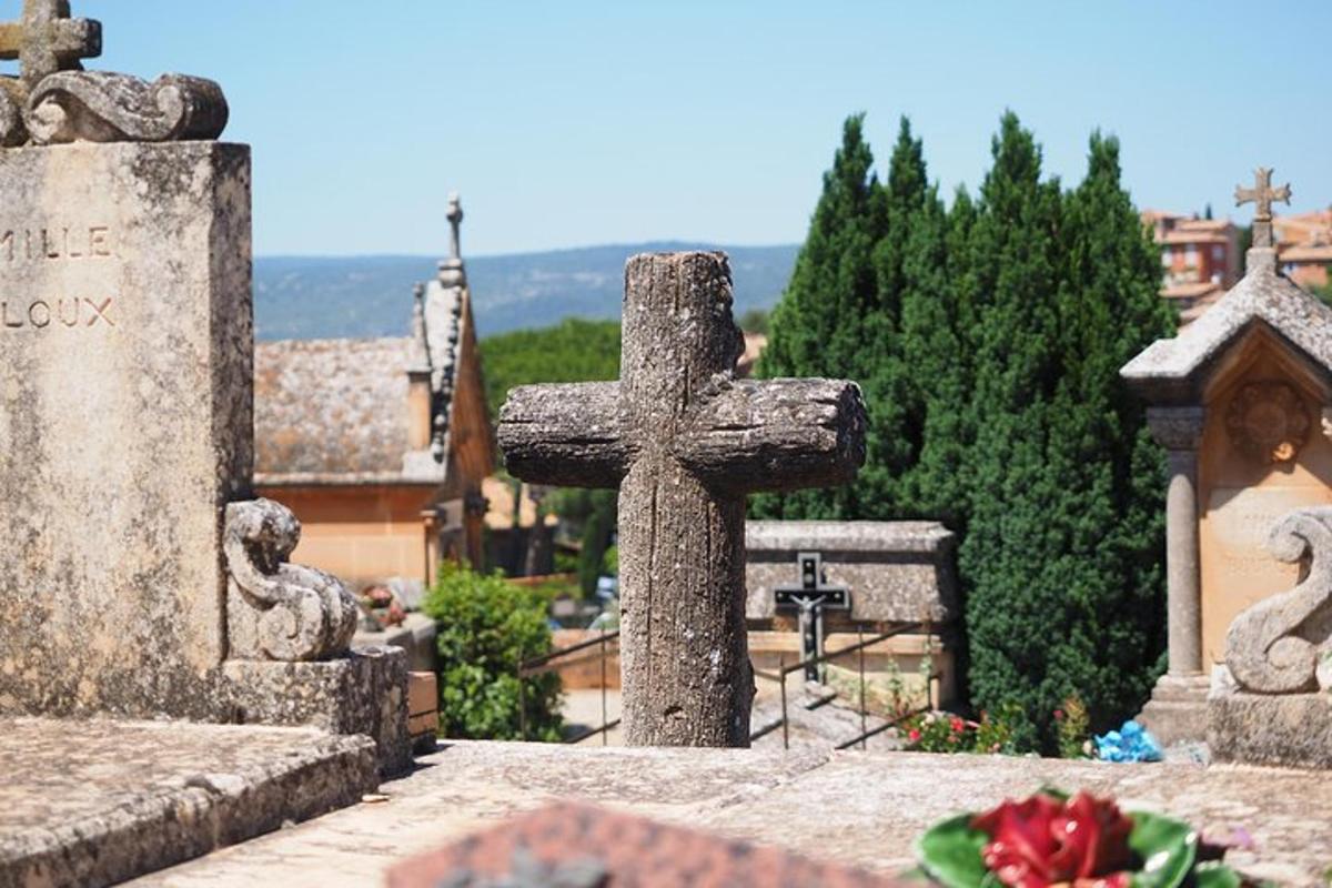 a grave with a cross in a cemetery