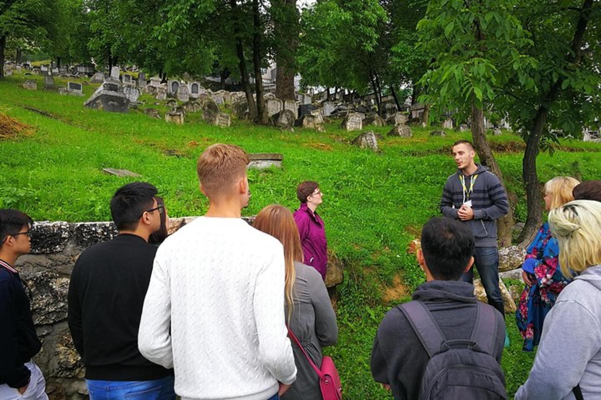 a group of people standing around in a cemetery