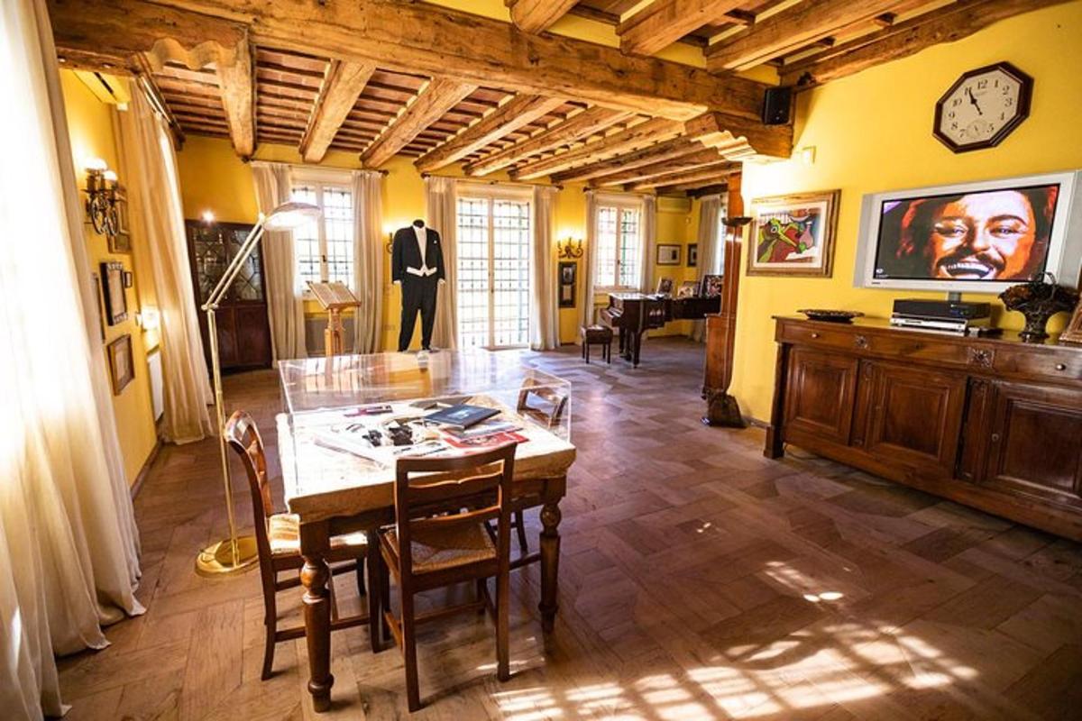 a dining room with a table with chairs and a clock