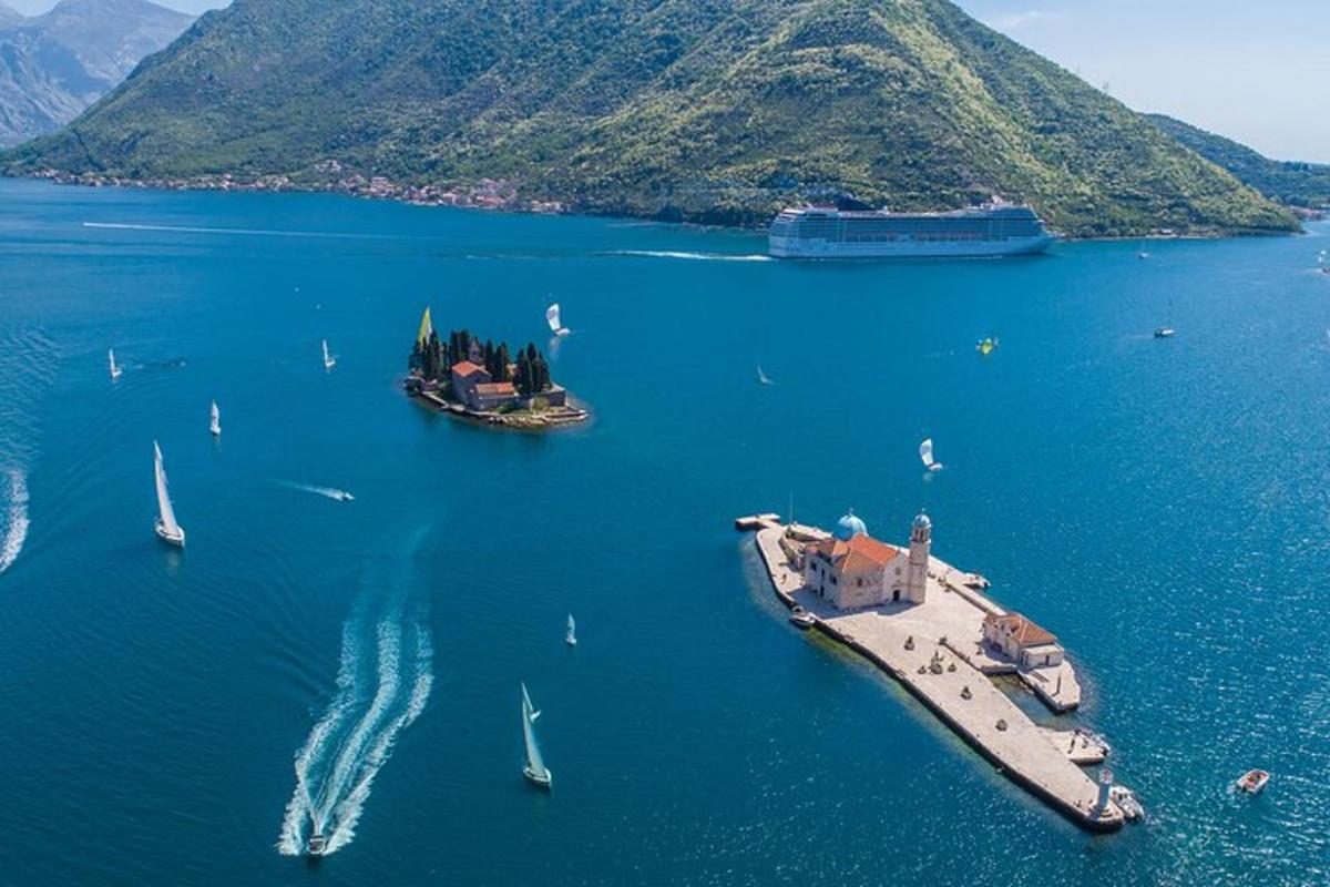 an island in a large body of water with boats