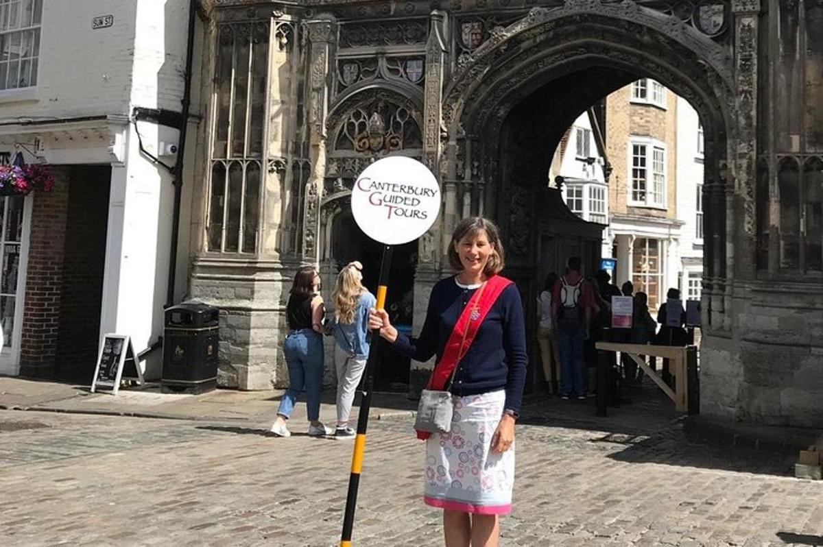 a woman holding a sign in front of a building