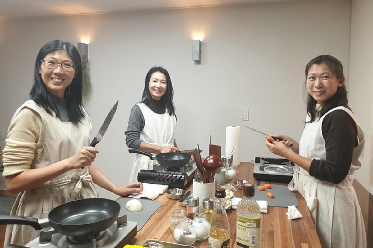 three women standing in a kitchen preparing food