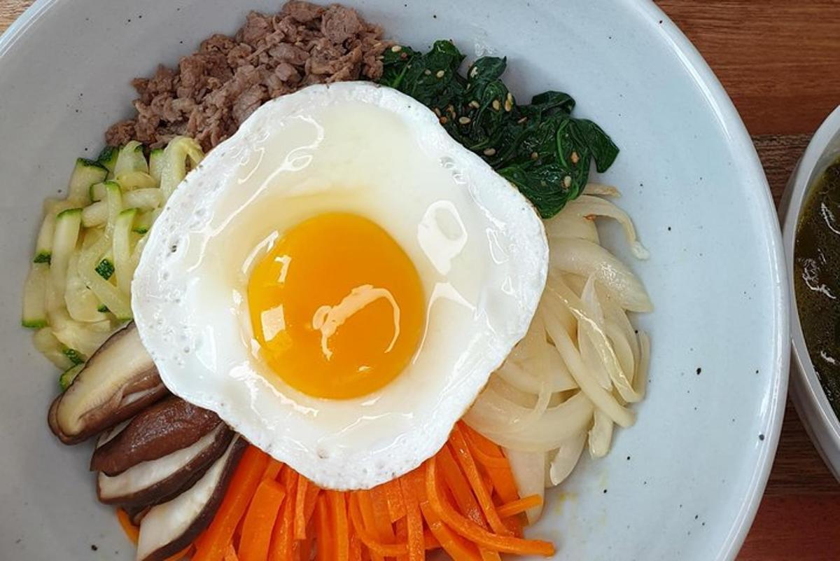 a plate of food with an egg and vegetables