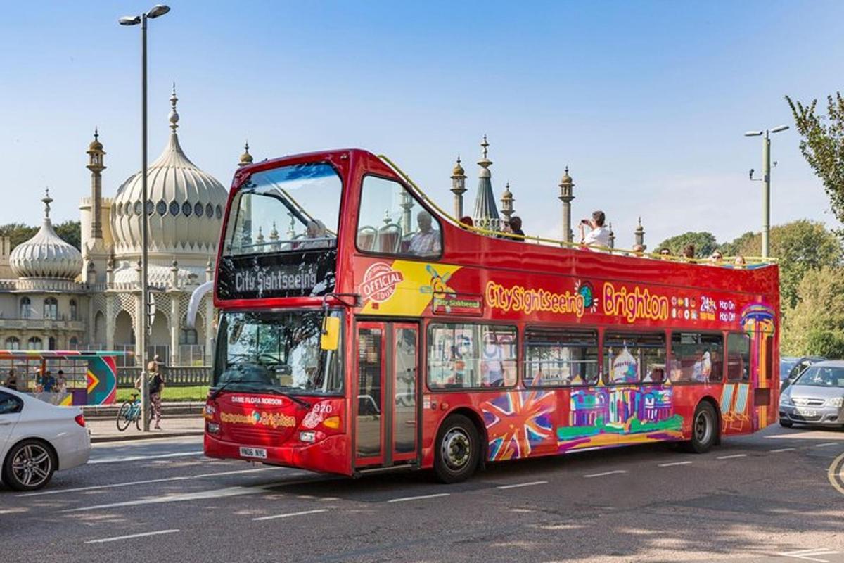 a red double decker bus driving down a street