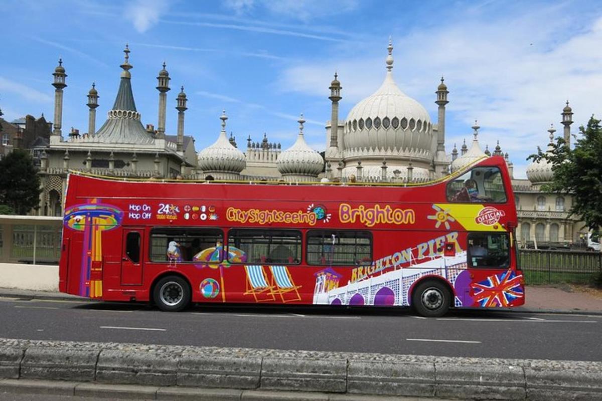 a red double decker bus in front of a building