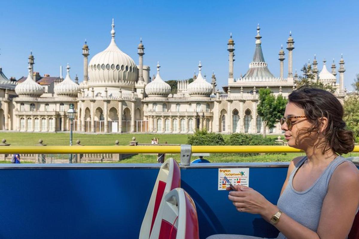 a woman sitting in front of a large building