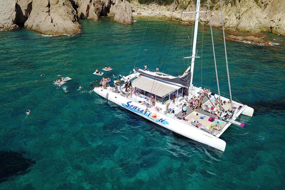 a group of people on a sail boat in the water