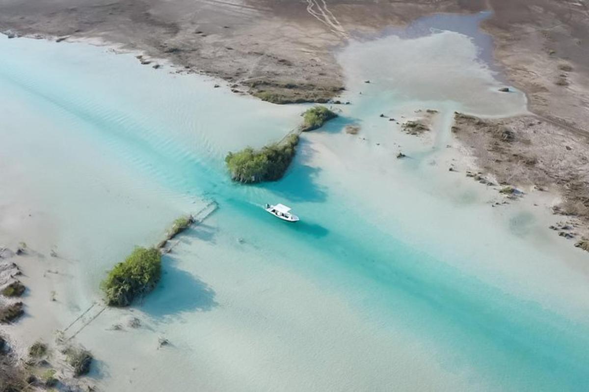 an aerial view of a boat in a body of water