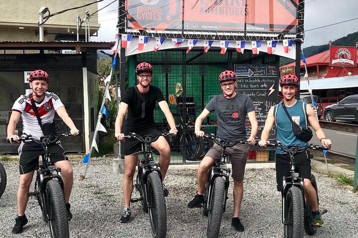 four men riding bikes in front of a store