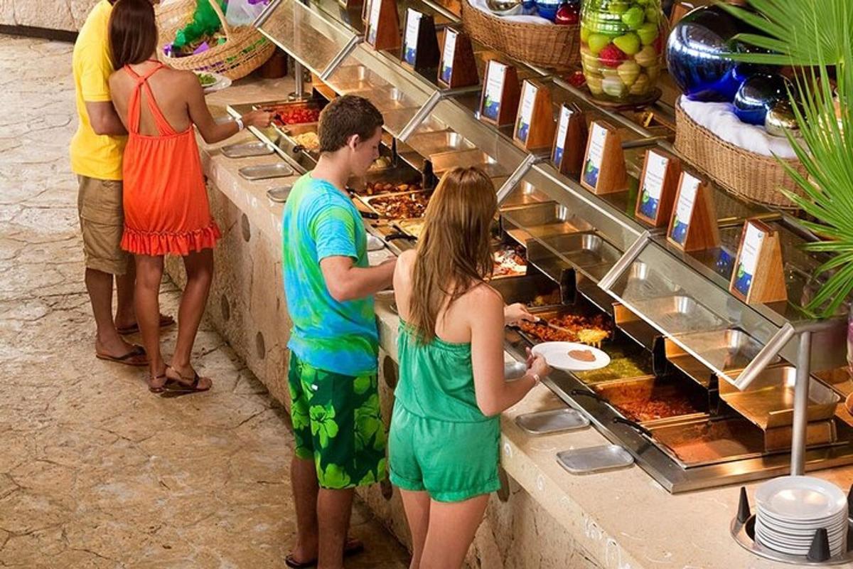 a group of people standing around a buffet of food