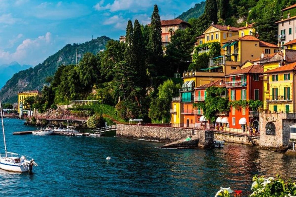 a boat in the water next to buildings on a river