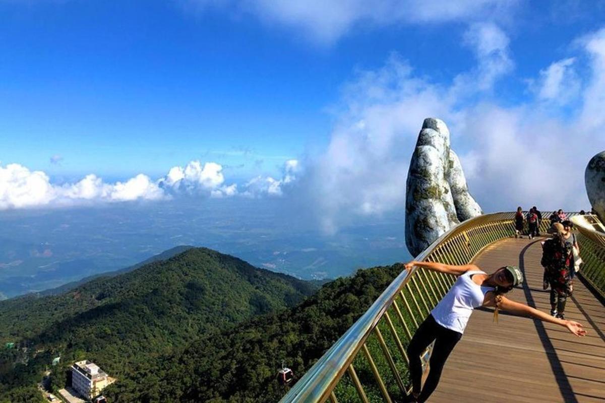 a man standing on a walkway at the peak of a mountain